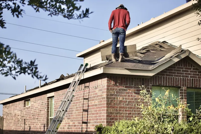 Professional roofer working on a residential roof in Woodridge Twin Homes